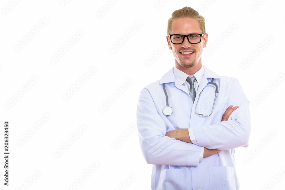Studio shot of happy handsome man doctor smiling with arms cross Studio shot of happy handsome man doctor smiling with arms cross