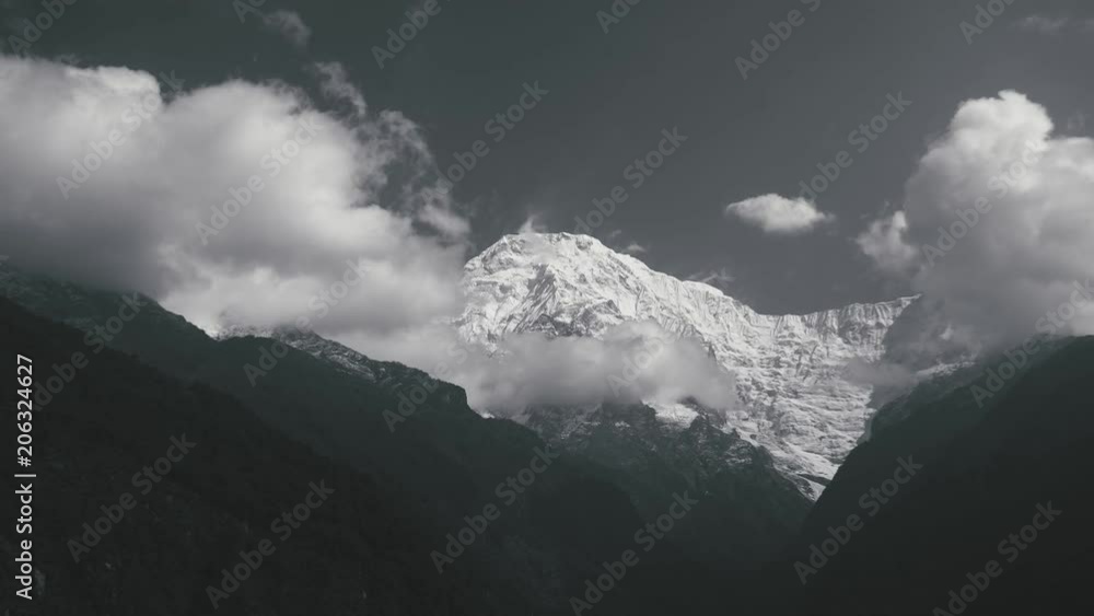 Time-lapse Moving the cloud on sky on peak of mountain covered snow, view on the way trekking Annapurna base camp range in black and white Time-lapse Moving the cloud on sky on peak of mountain covered snow, view on the way trekking Annapurna base camp range in black and white
