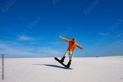 Sand boarding in desert at sunny day