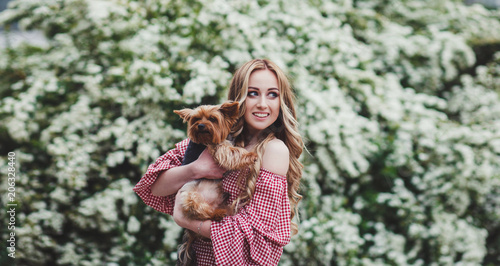 portrait of the beautiful young woman with dog in park