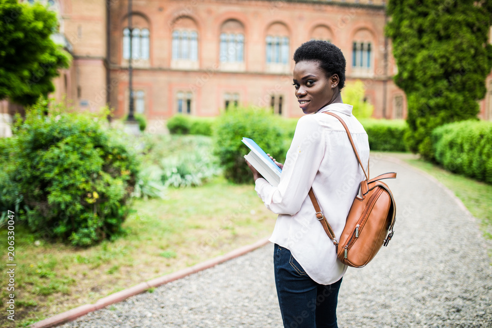 Obraz premium Time to get knowledge. Beautiful female african american university student portrait