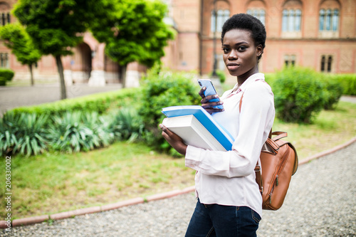 Use this app. happy young african american uni student using cell phone