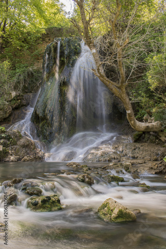 Fototapeta Naklejka Na Ścianę i Meble -  The Boaza waterfall is located near the main road Varna - Sofia in the Boaza area. It is a small waterfall about 5 meters away and has been formed by a small underground stream of the Vrana River.
