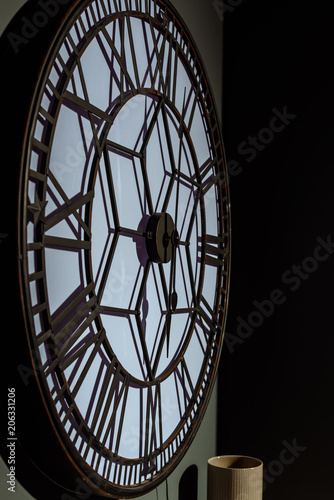 big vintage wall clock in modern green room