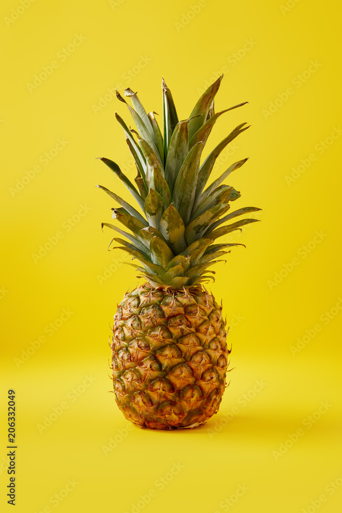 close up view of fresh pineapple on yellow background