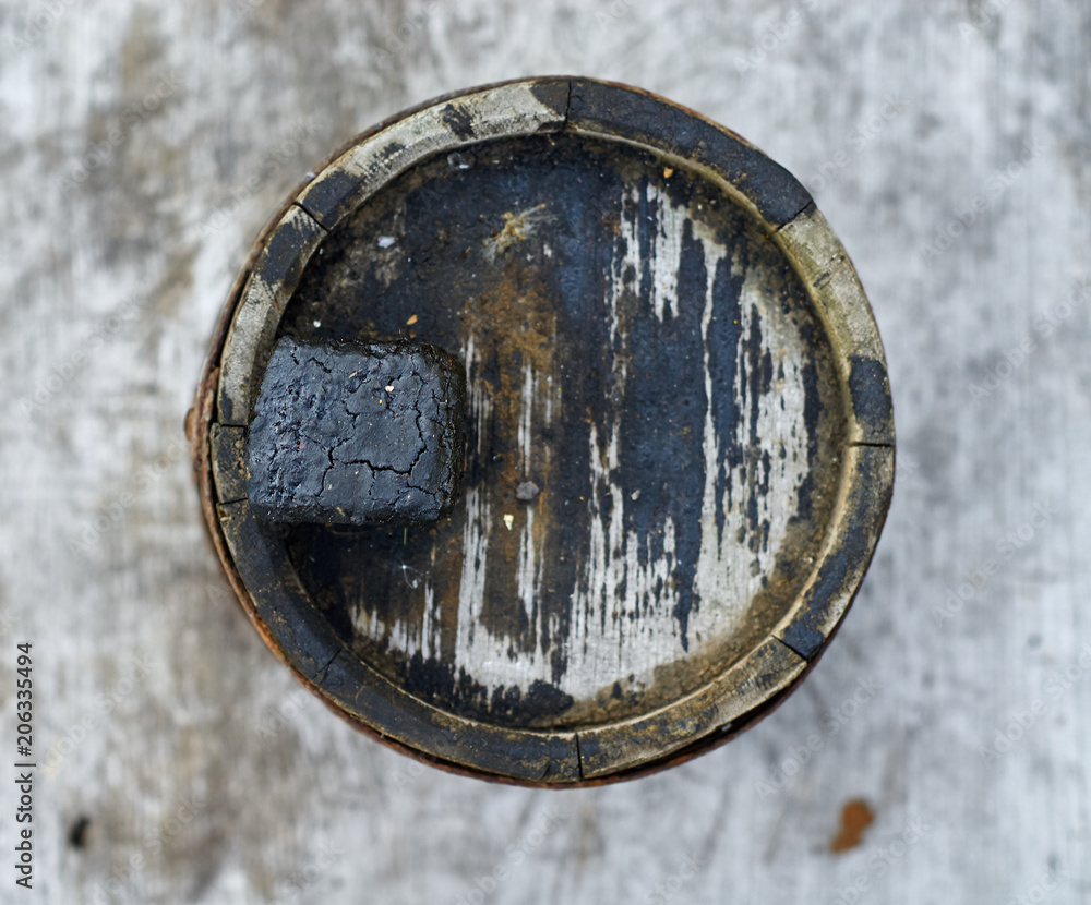 Old grimy wooden barrel for fuel oil