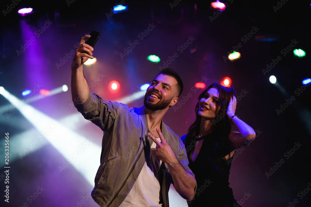 Couple take a selfie with a mobile in the night celebration