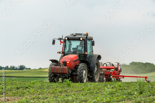 Farmer seeding  sowing crops at field. Sowing is the process of planting seeds in the ground as part of the early spring time agricultural activities.