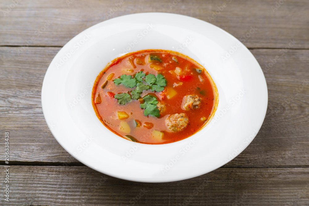 Italian national meals, minestrone soup with meat balls. Home food, restaurant cuisine, menu concept Italian national meals, minestrone soup with meat balls. Home food, restaurant cuisine, menu concept