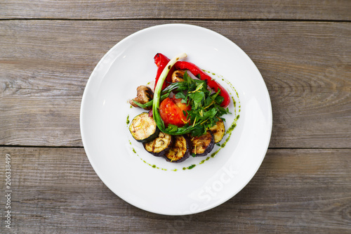 Healthy vegetarian food, Mediterranean cuisine, restaurant menu. Grilled vegetables with herbs, pesto sauce and balsamic vinegar