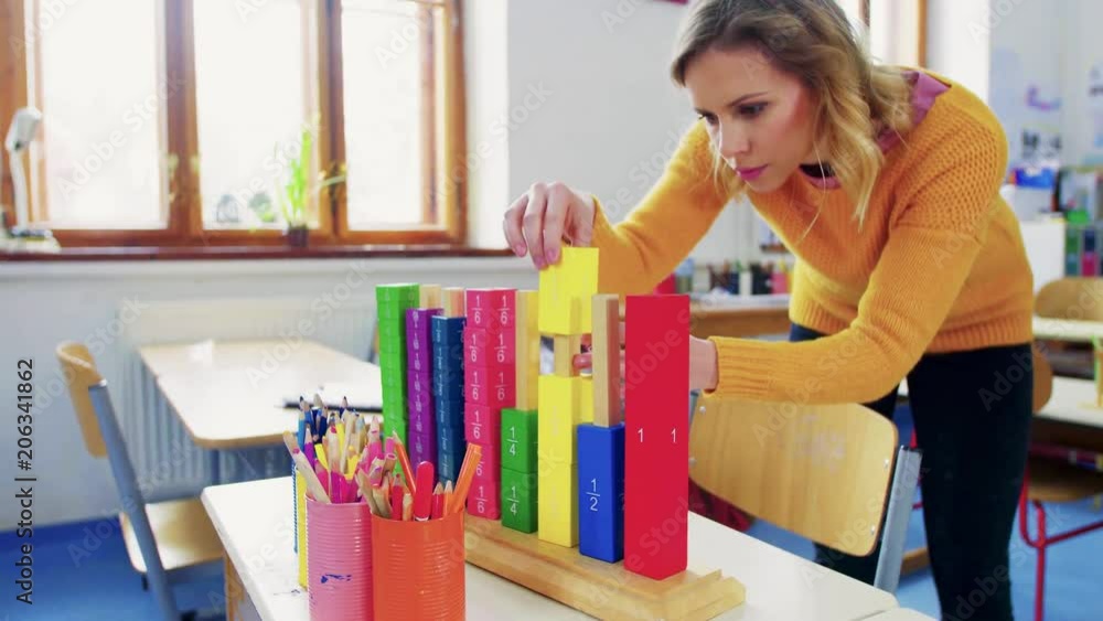 A young woman teacher in the classroom at school. A young woman teacher in the classroom at school.