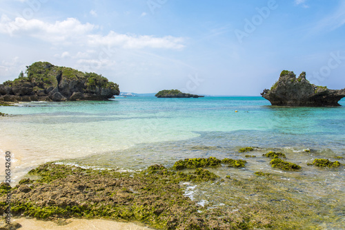 Beautiful ocean and white tropical beach with rocks, in Okinawa Japan.