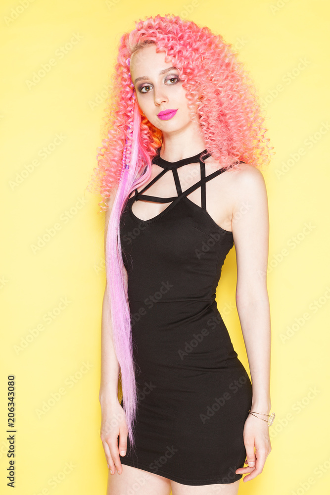 Beautiful girl with long wavy pink hair . Model with curly hairstyle Beautiful girl with long wavy pink hair . Model with curly hairstyle