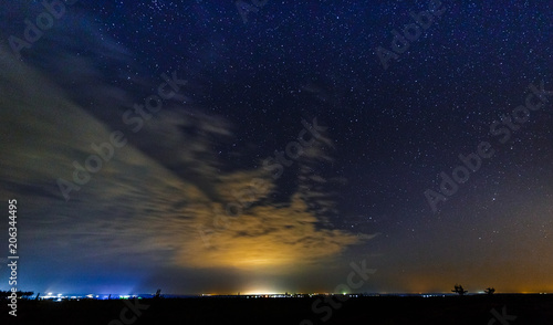 Starry sky and illuminated clouds.