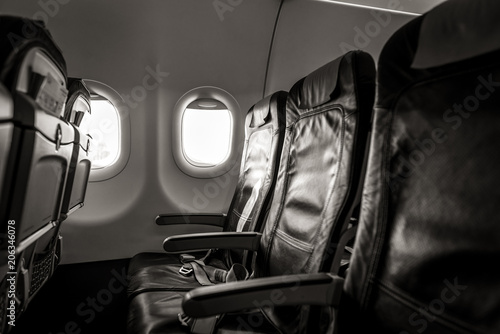 Interior of airplane with empty seats and sunlight at the window. Travel concept © bychykhin