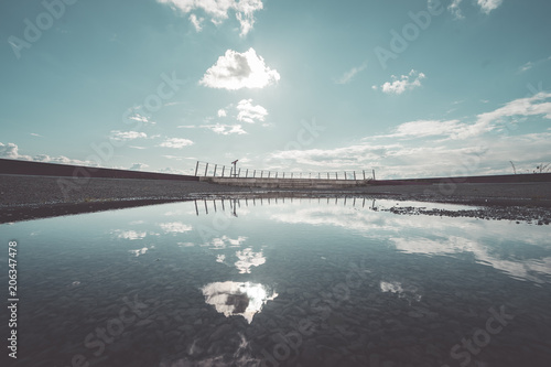 Wallpaper Mural Wasserpfütze auf Asphalt mit Reflektion des Himmels Torontodigital.ca