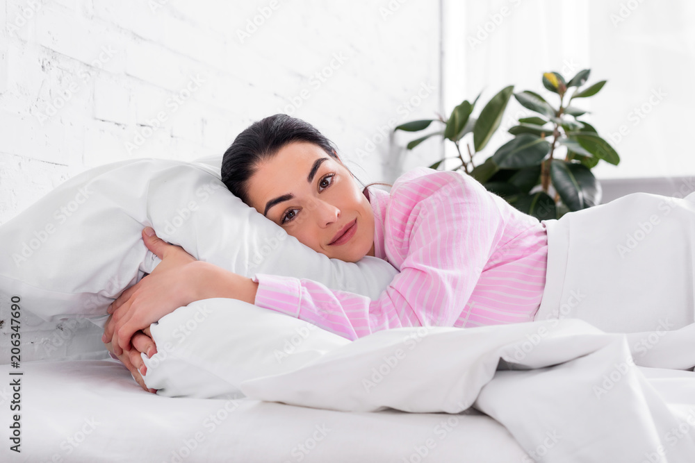 portrait of woman in pink pajamas resting in bed in morning at home portrait of woman in pink pajamas resting in bed in morning at home