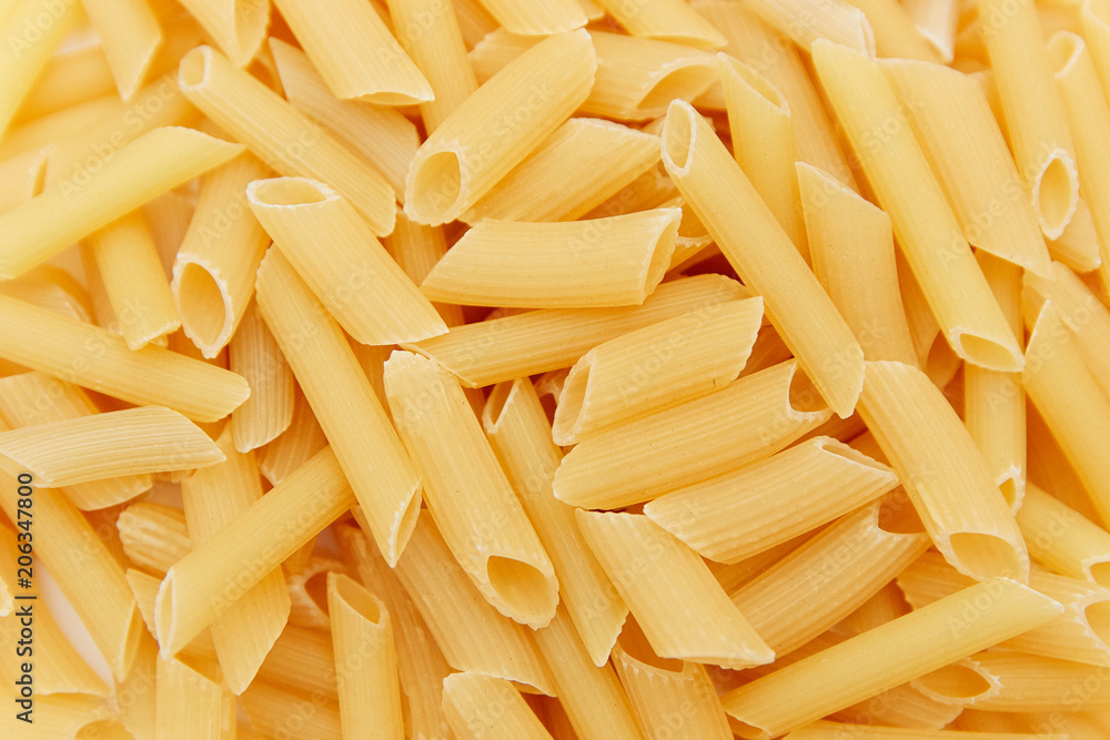 heap of raw pasta. top view. background. close up. italian food or cuisine heap of raw pasta. top view. background. close up. italian food or cuisine