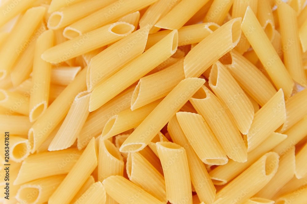 heap of raw pasta. top view. background. close up. italian food or cuisine heap of raw pasta. top view. background. close up. italian food or cuisine