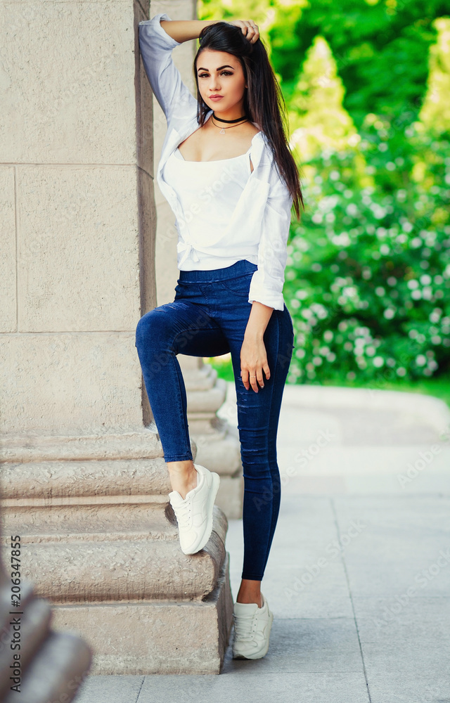 young sexy stylish girl, slim tall girl in jeans and shirt on the ...