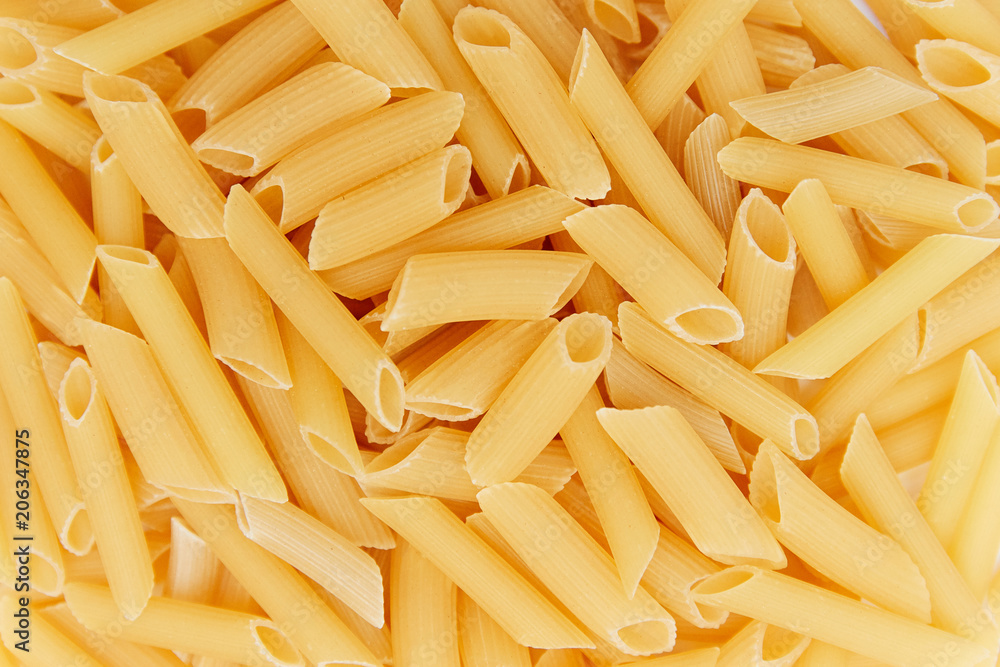 heap of raw pasta. top view. background. close up. italian food or cuisine heap of raw pasta. top view. background. close up. italian food or cuisine