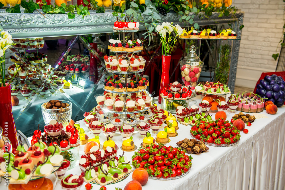 Delicious sweets on candy buffet. Lot of colorful desserts