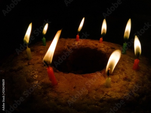 Homemade Birthday cake with candles in dark