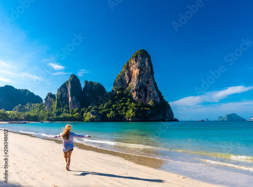 Woman running on Railay beach Krabi Thailand. Asia