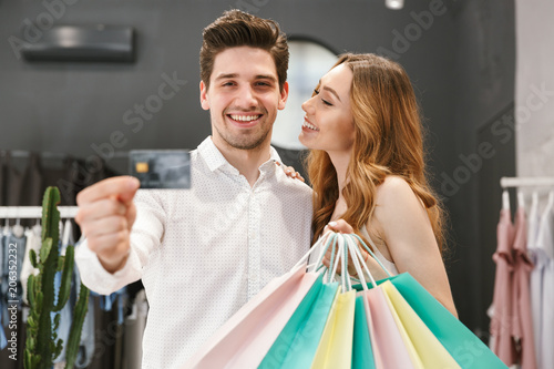 Satisfied young couple shopping for clothes together