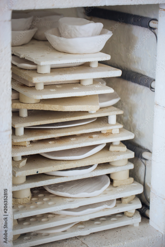 Handcrafted on a potter's wheel,Hands make clay from various items for home and sale in the store and at the exhibition, ceramic items are made in hand, the clay billet becomes a ceramic dish Handcrafted on a potter's wheel,Hands make clay from various items for home and sale in the store and at the exhibition, ceramic items are made in hand, the clay billet becomes a ceramic dish
