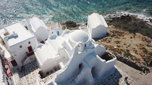 Aerial drone bird's eye view photo of iconic church of Paraportiani in Little Venice, Chora of Mykonos island, Cyclades, Greece