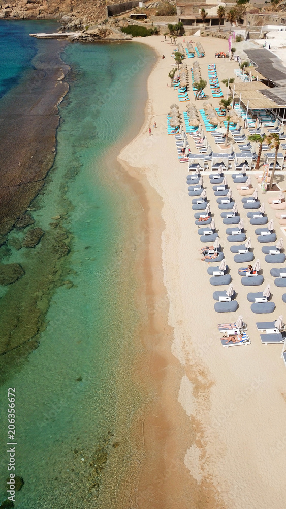 Aerial drone, bird's eye view photo of iconic and famous beach of Super Paradise with sapphire clear waters, Mykonos island, Cyclades, Greece