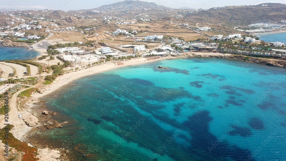Aerial drone bird's eye view of famous Paraga beach featuring iconic beach bar of Skorpios and Santa Anna, Mykonos island, Cyclades, Greece Aerial drone bird's eye view of famous Paraga beach featuring iconic beach bar of Skorpios and Santa Anna, Mykonos island, Cyclades, Greece