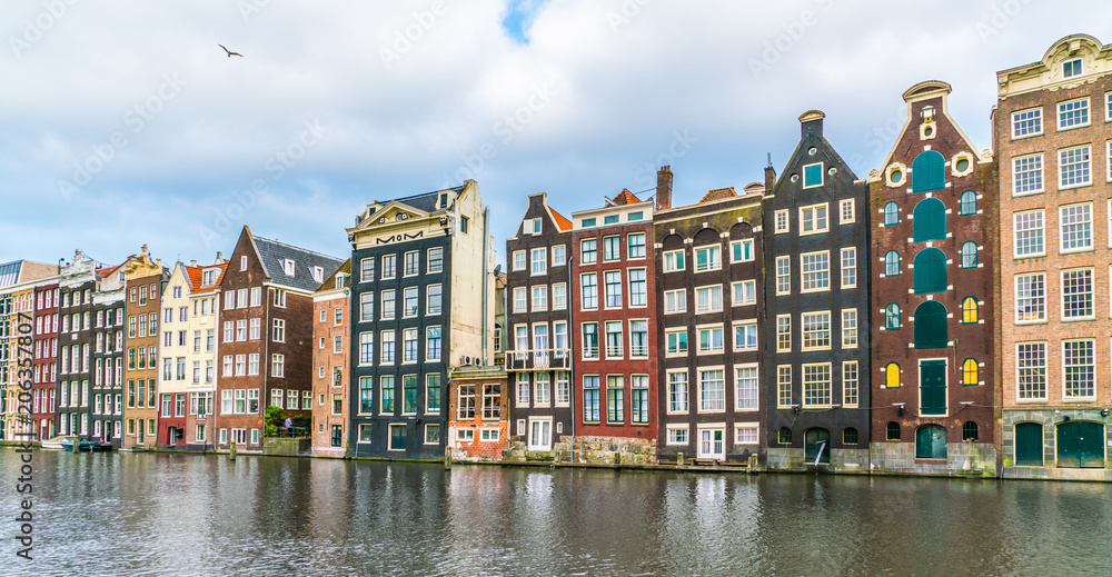 A row of old traditional houses at the Damrak in Amsterdam