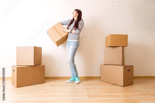 Image of young woman among cardboard boxes © nuclear_lily