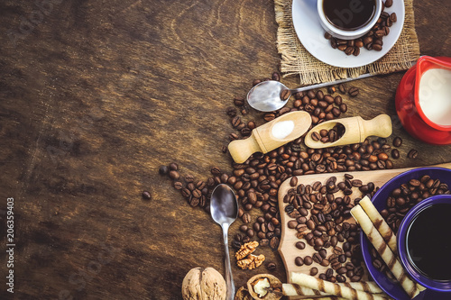 cup and coffee beans. a jug of milk. wooden background. © Михаил 