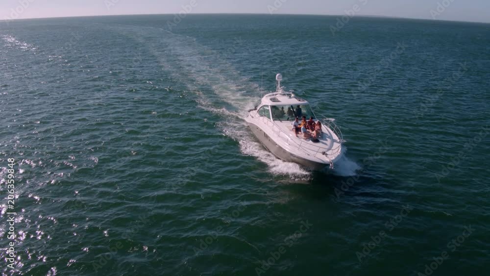 View from drone of young people relaxing on a yacht deck. Group of friends on a yacht deck on a summer day.
View from drone of young people relaxing on a yacht deck. Group of friends on a yacht deck on a summer day.