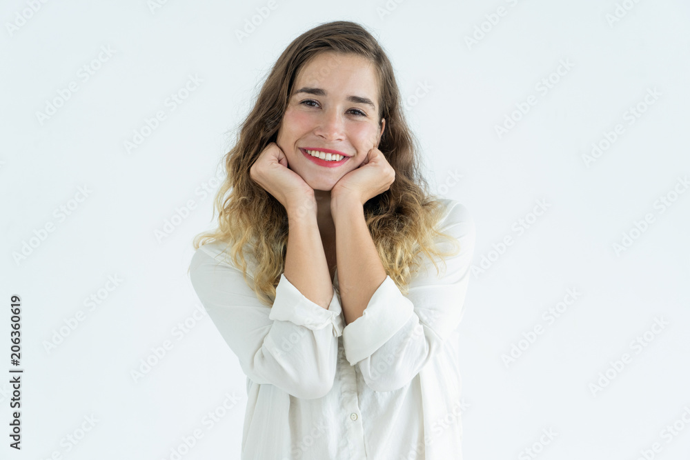Smiling young pretty woman standing and leaning head on hands Smiling young pretty woman standing and leaning head on hands