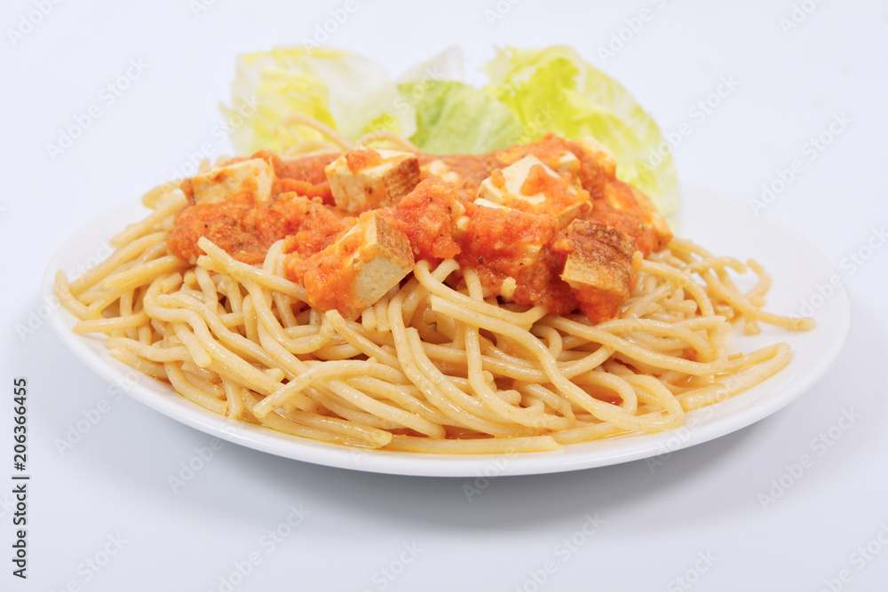 Bolognese spaghetti with tofu on a white Bolognese spaghetti with tofu on a white