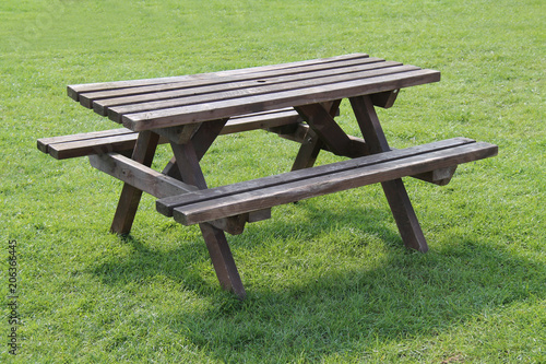 A Traditional Outdoor Wooden Picnic Table with Seats.