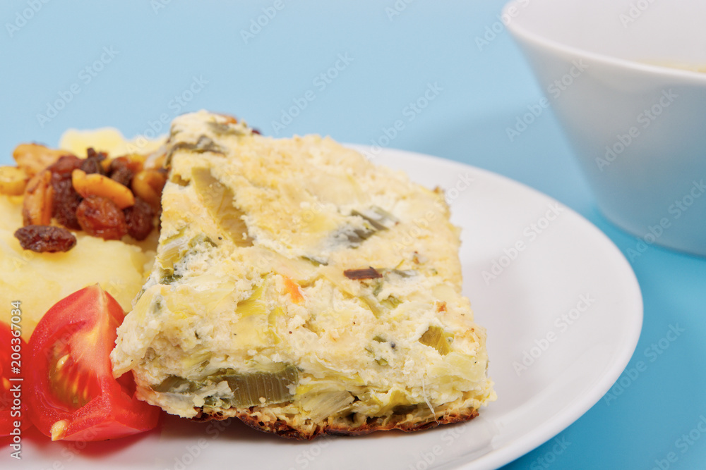 Baked leek with mashed potatoes on a blue Baked leek with mashed potatoes on a blue
