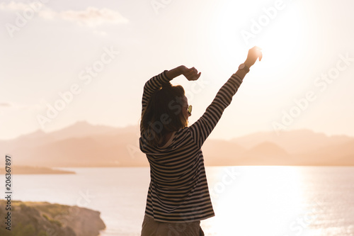 Girl enjoying sunset in Penya Fort Majorca Spain photo