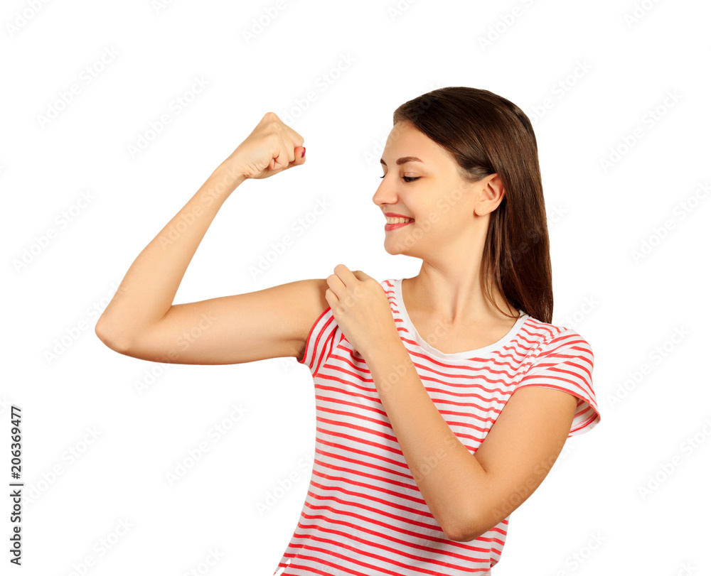 smiling girl is pointing at her bicep. emotional girl isolated on white background smiling girl is pointing at her bicep. emotional girl isolated on white background