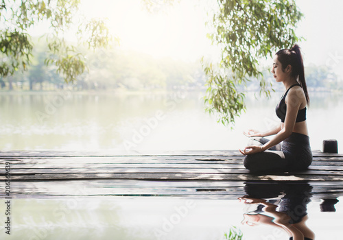 young women meditate while doing yoga