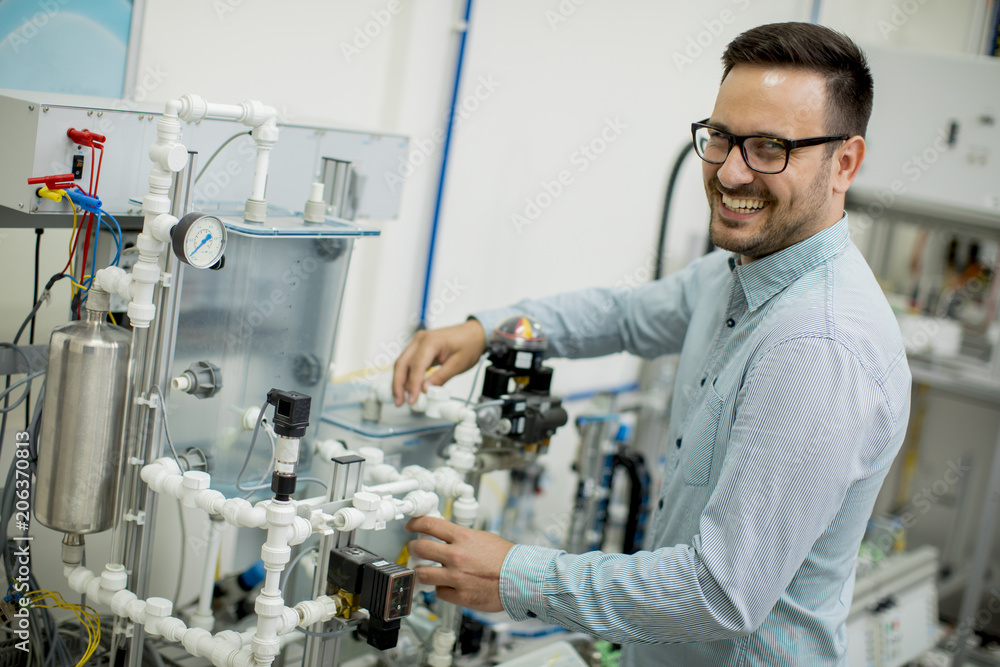 Handsome young man in the electronic workshop Handsome young man in the electronic workshop