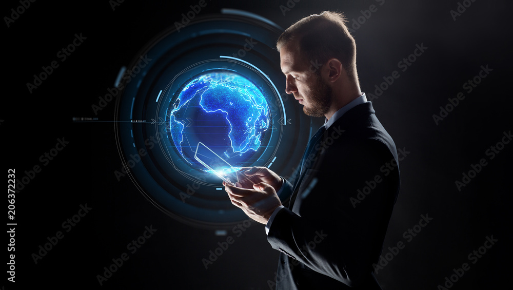 business, globalization and future technology concept - businessman with transparent tablet pc computer and earth hologram over black business, globalization and future technology concept - businessman with transparent tablet pc computer and earth hologram over black