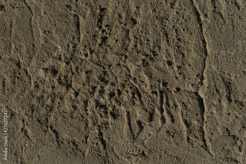 background, texture - brown clay wall with bumps and cracks