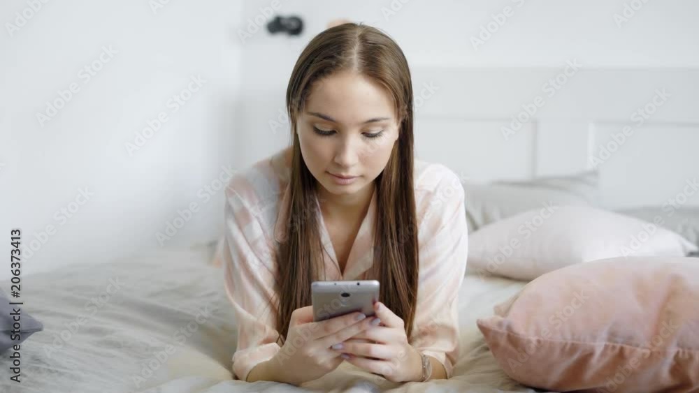 Beautiful female holding mobile phone in hand Beautiful female holding mobile phone in hand