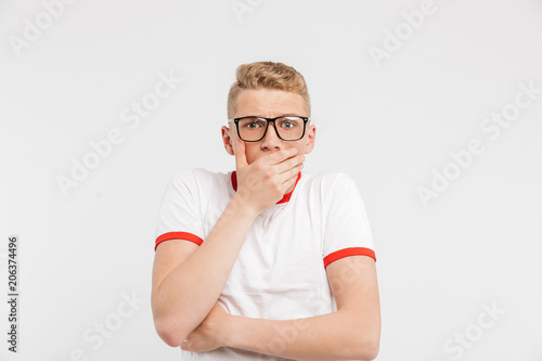 Portrait of a shocked teenage boy in eyeglasses © Drobot Dean