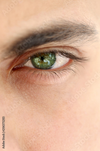 Φωτογραφία Close up on a green eye of a man, unrecognizable